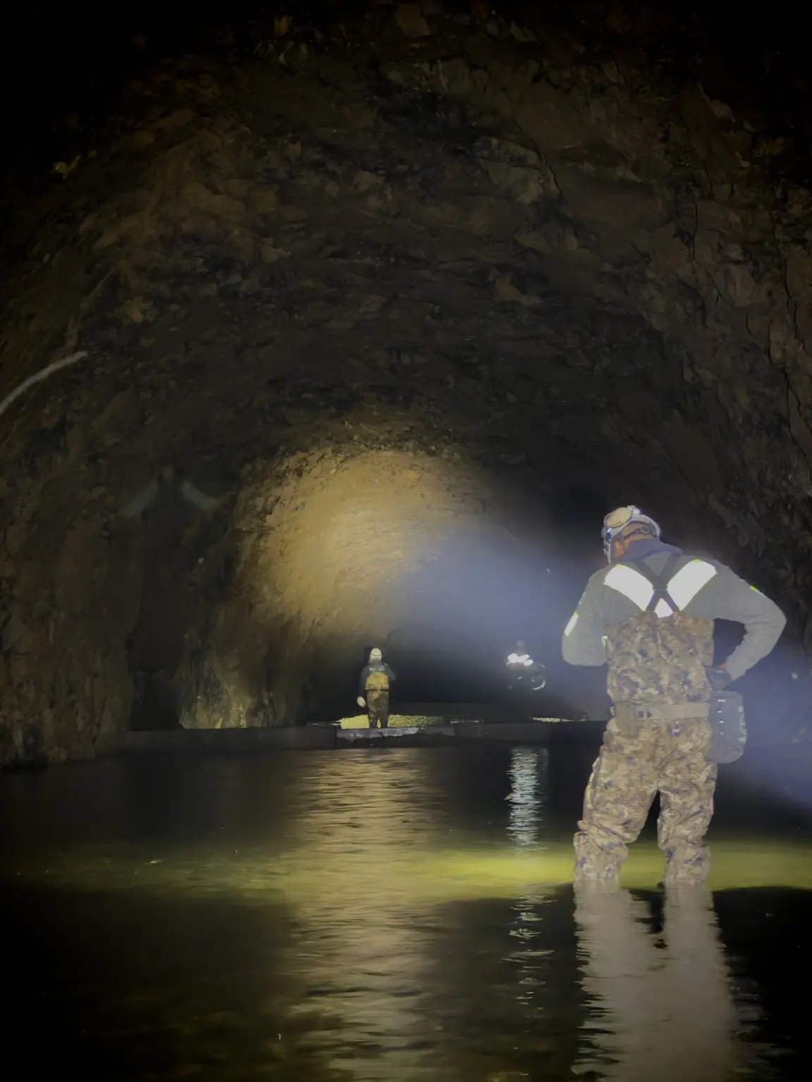 Team working in a flooded underground tunnel